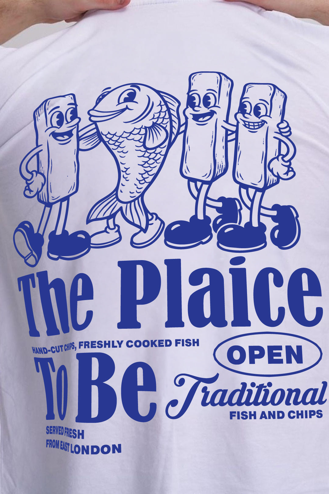 White t-shirt with cartoon fish and chips graphic and The plaice to be text on the back.