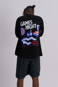 Man wearing a black t-shirt with a colourful games night graphic on the back against a grey background