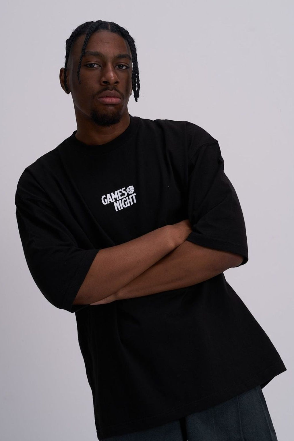 Man wearing a black t-shirt with 'Games Night' text on a plain background