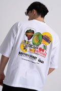 Male wearing a white t-shirt with colourful fruit graphics and text on the back.