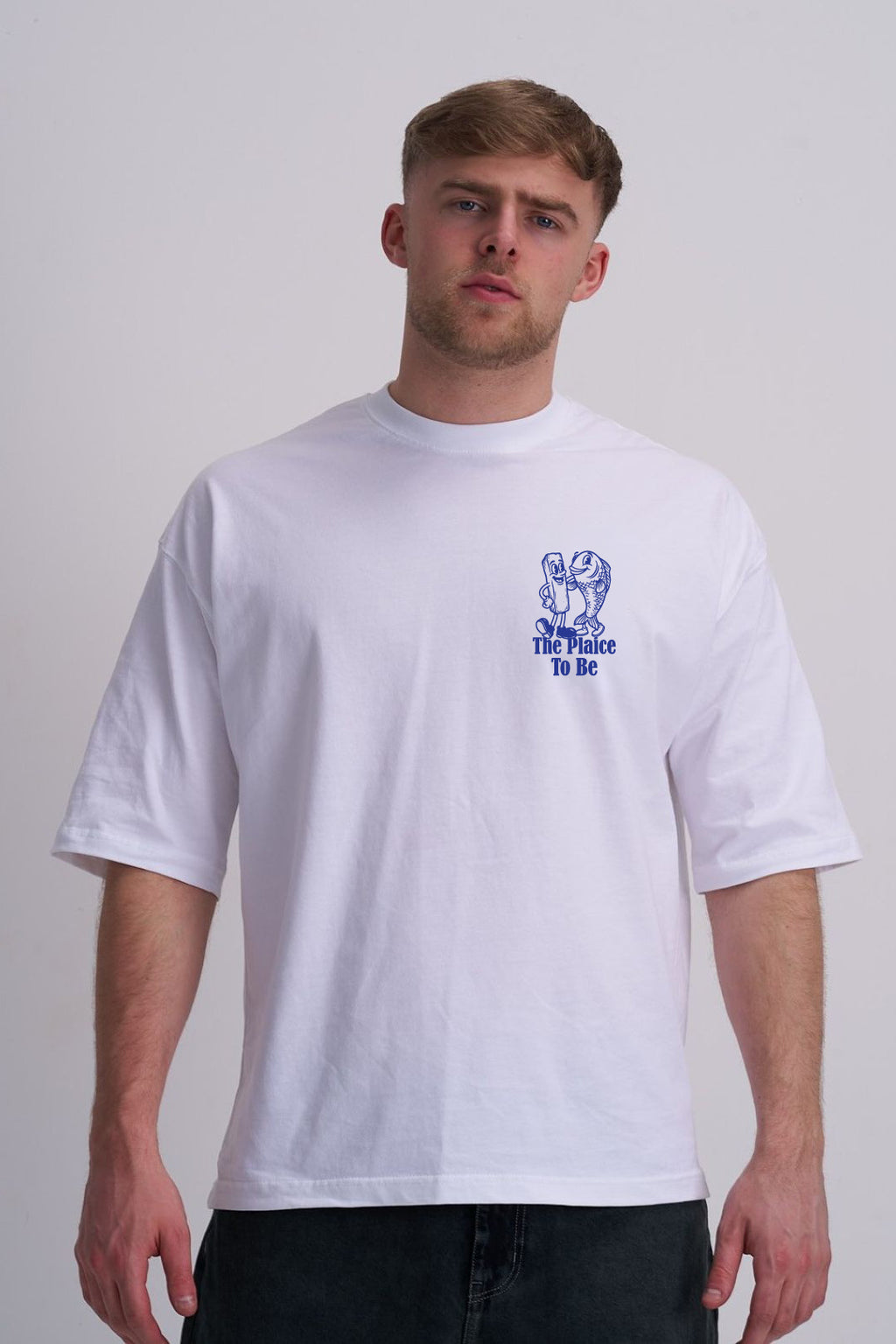 Man wearing a white t-shirt with a blue fish and chips graphic design on a plain background