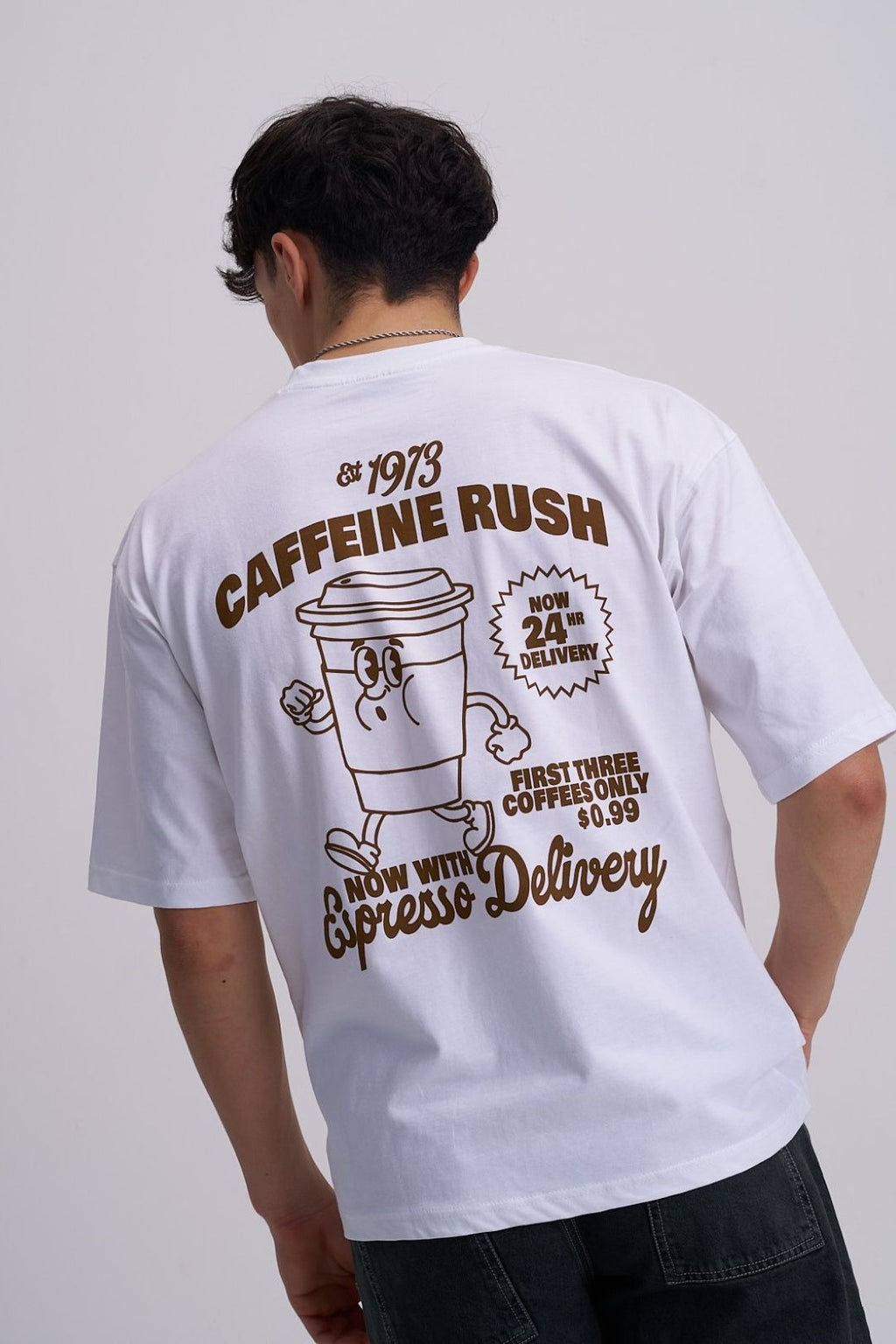 Man wearing a white t-shirt with a coffee-themed design on the back.