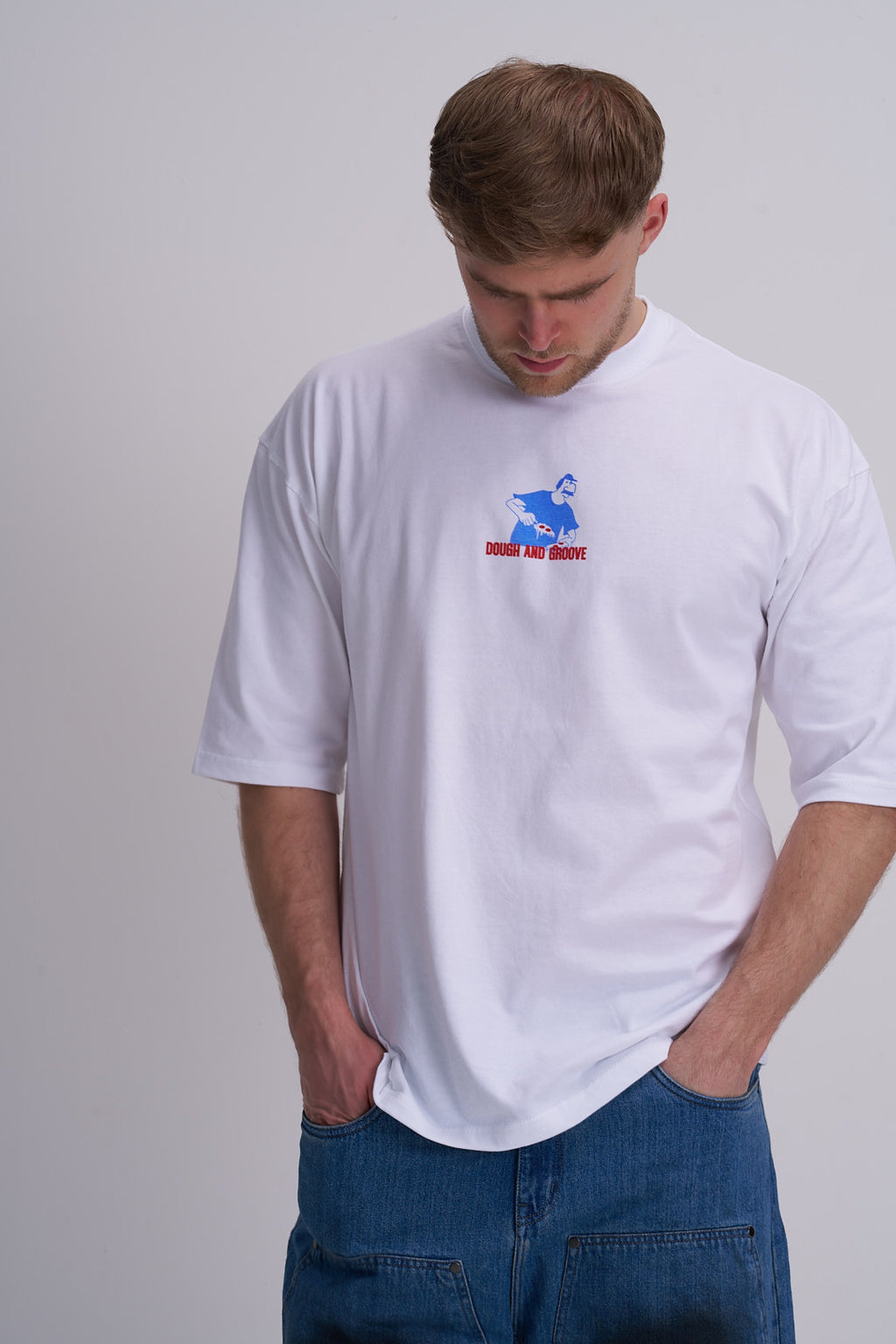 Man wearing a white t-shirt with a blue logo of a pizza man on a plain background