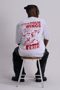 Male wearing a white tee with fast food graphic in red, sitting on a stool