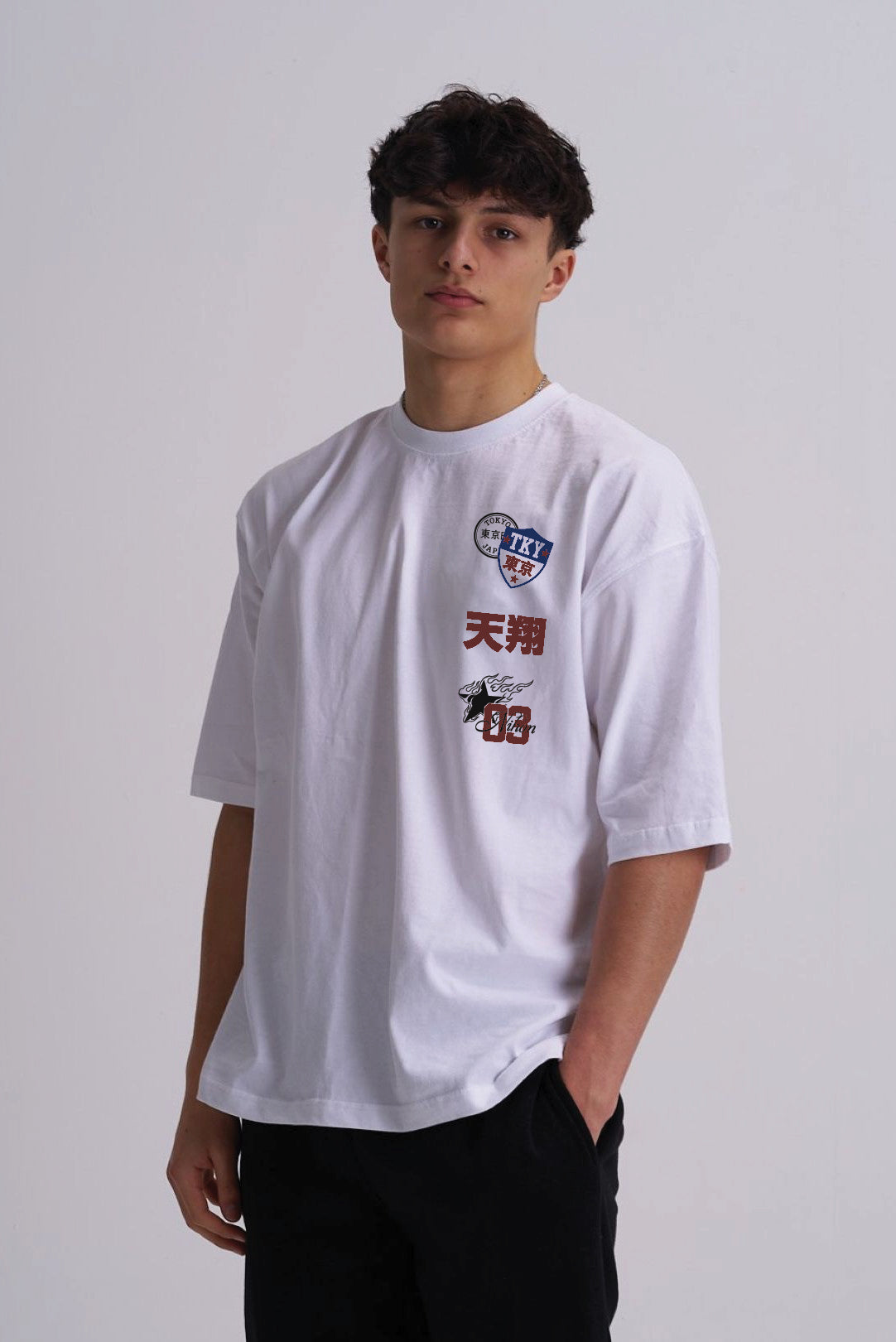 Man wearing a white t shirt with Japanese badge design on the front