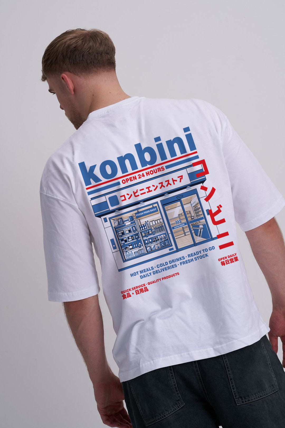 Person wearing a white t-shirt with konbini Japanese convenience store graphic design on the back.