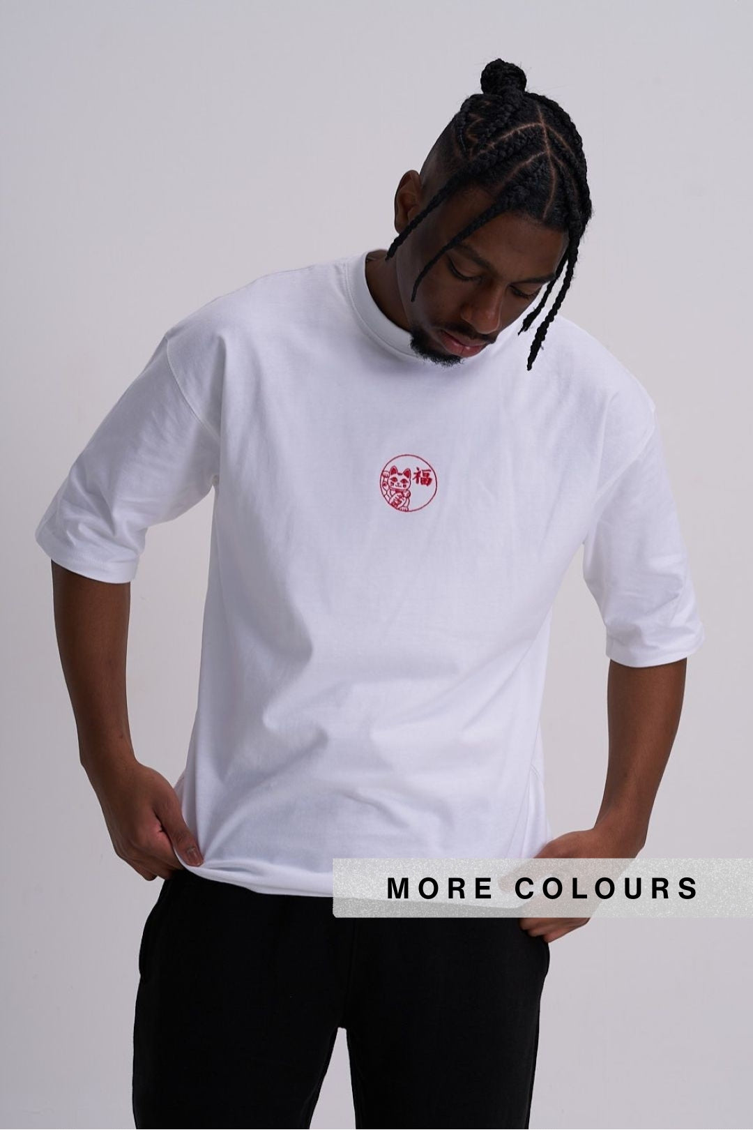 Person wearing a white t-shirt with a red lucky cat embroidered logo on the front