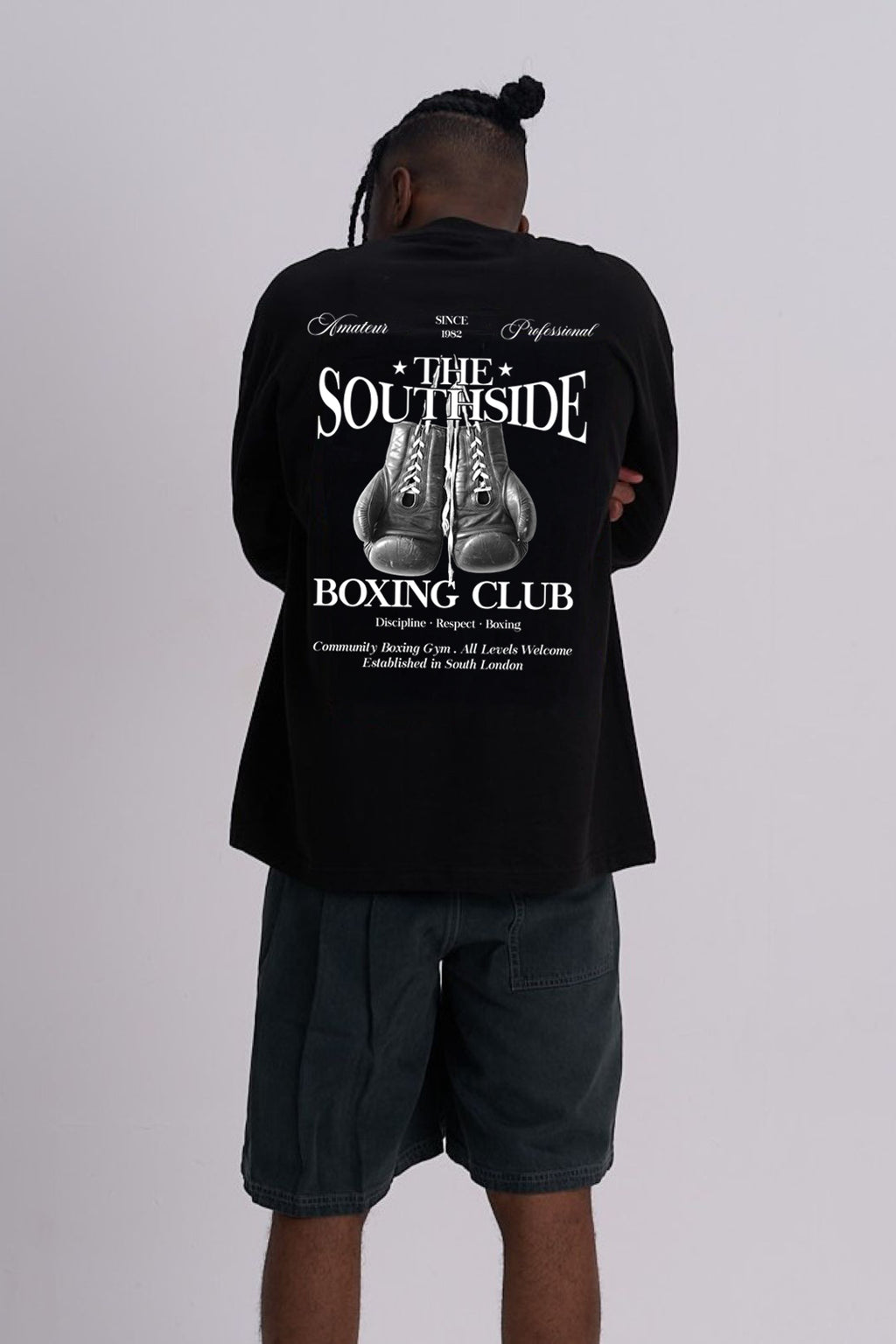 Person wearing a black T-shirt with 'Southside Boxing Club' design on the back, standing against a plain background.