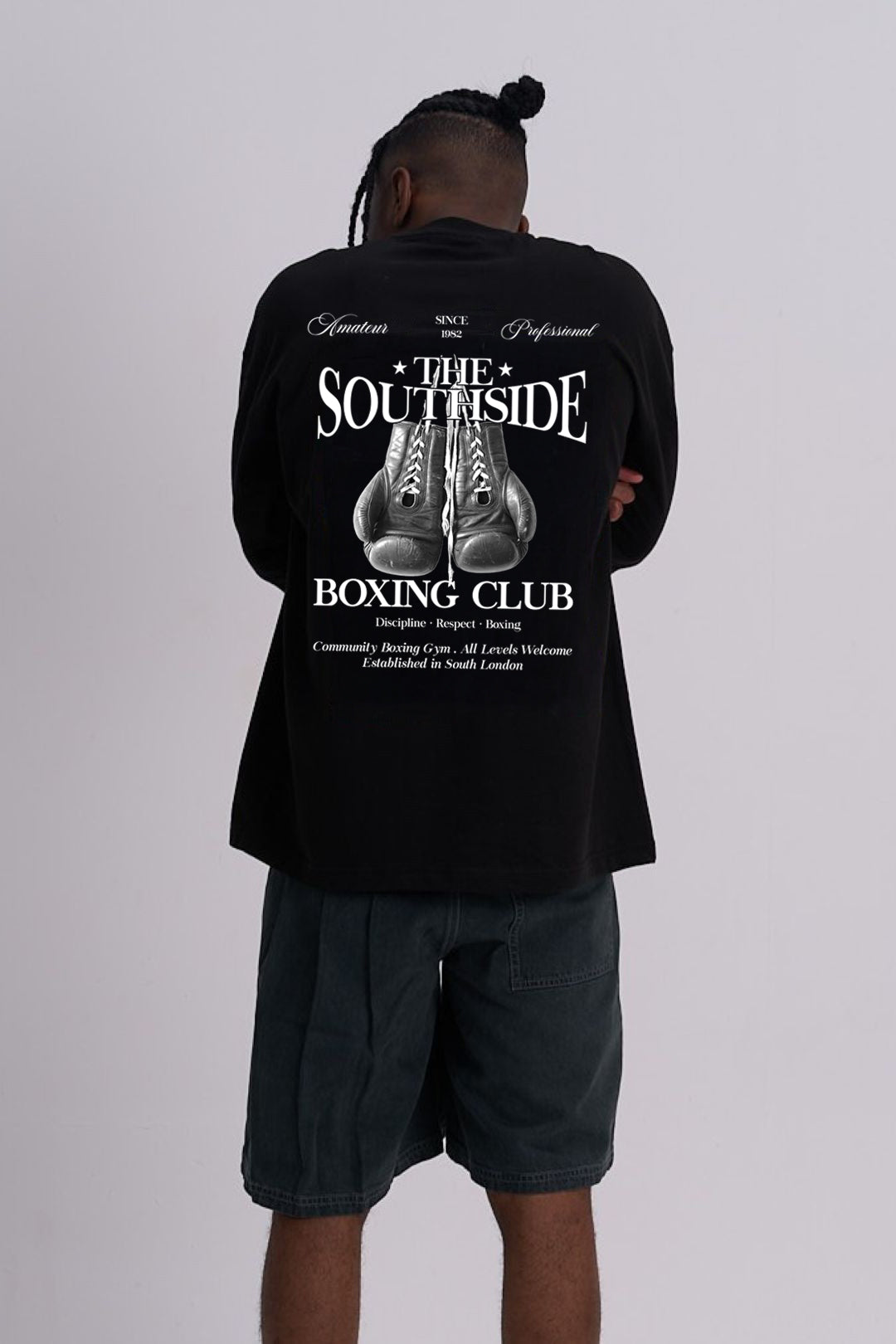 Person wearing a black T-shirt with 'Southside Boxing Club' design on the back, standing against a plain background.