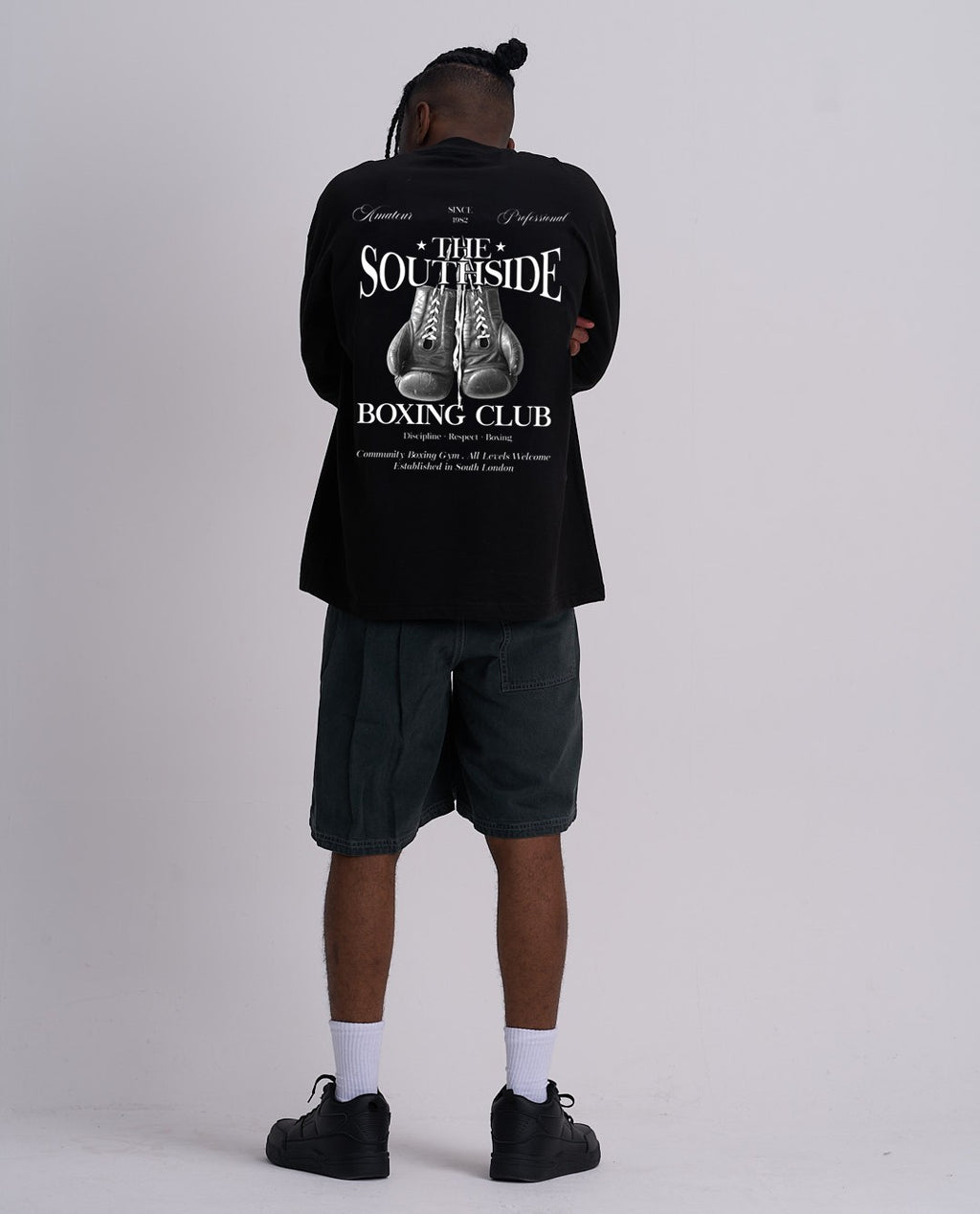 Person wearing a black t-shirt with 'Southside Boxing Club' design on the back, standing against a plain background.