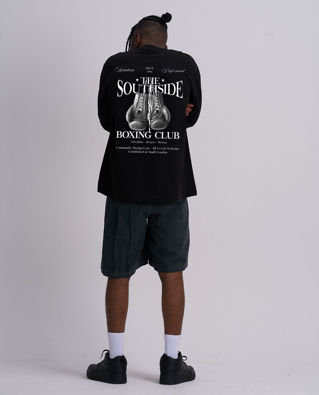Person wearing a black t-shirt with 'Southside Boxing Club' design on the back, standing against a plain background.