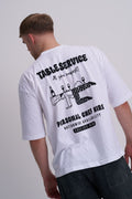 Male wearing a white t-shirt with black text "Table service - personal chef hire and chef graphic on the back.