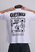 Man wearing a white t-shirt with 'The Daily Grind' graphic design on the back.