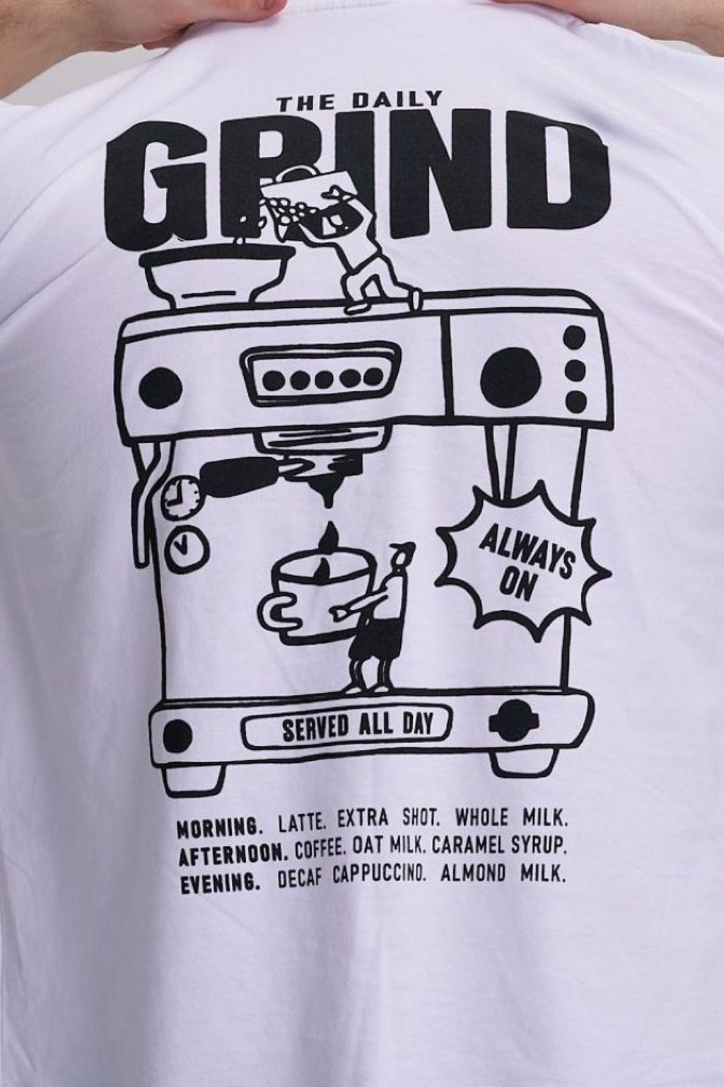 White t-shirt with black graphic design of a coffee machine and text on the back
